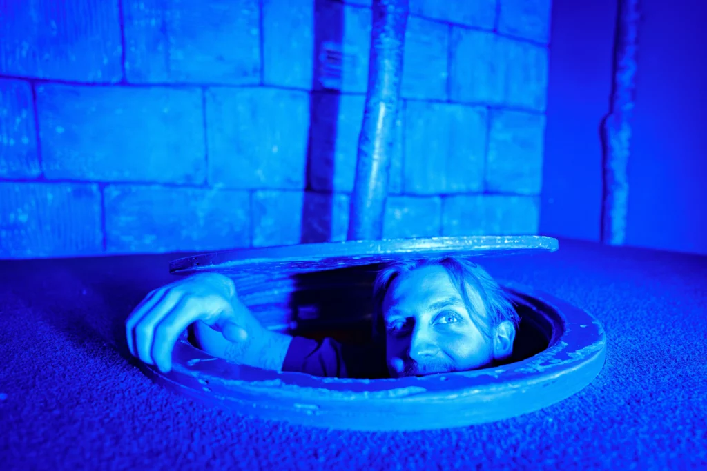 A person looking up from a hatch